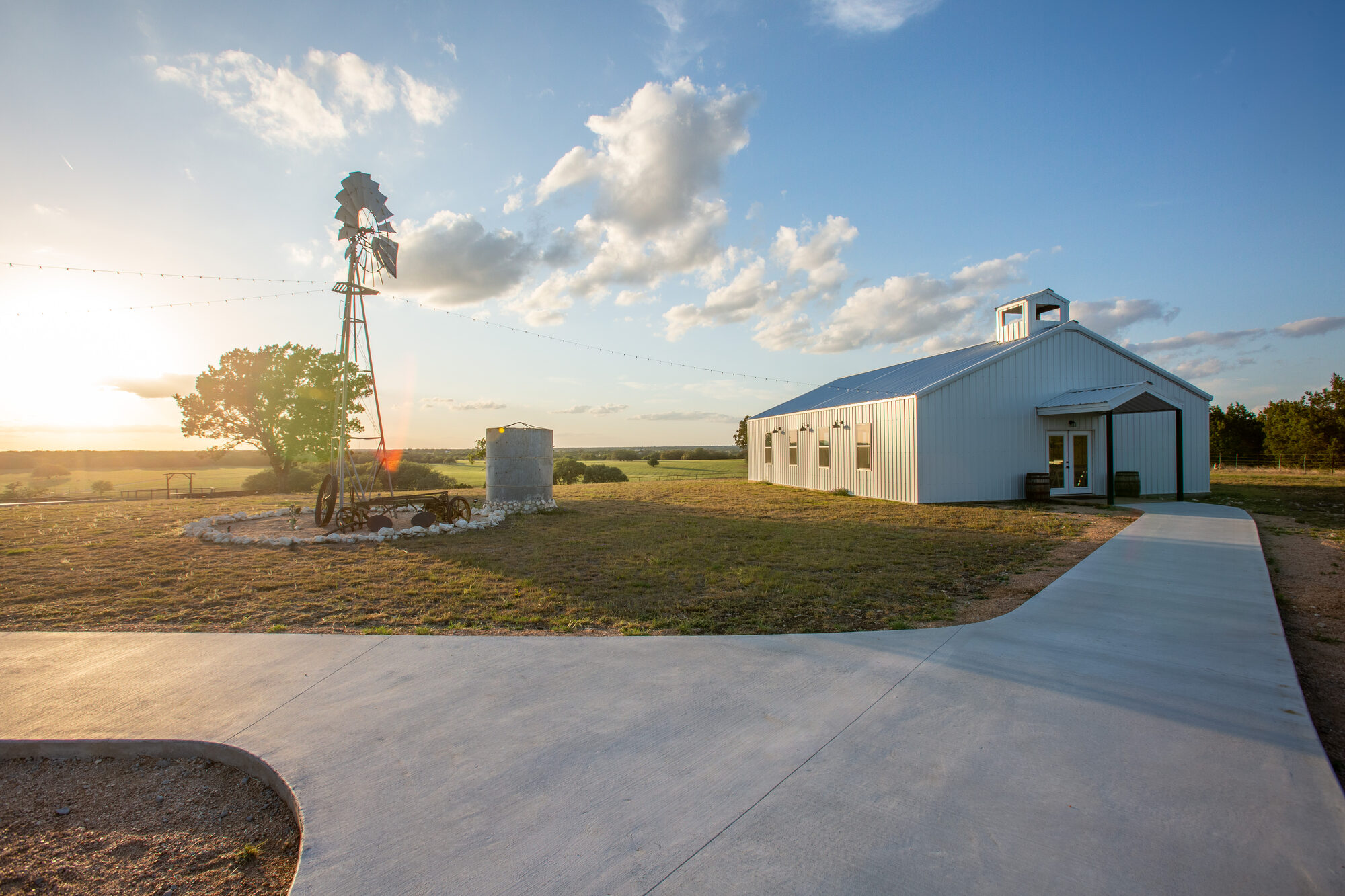 The Wagon Springs Ranch chapel and windmill at sunset
