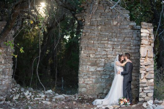 Couple embracing in the stone ruins on the property