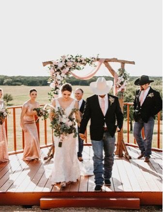 Bride and groom recessional on the deck with blush florals